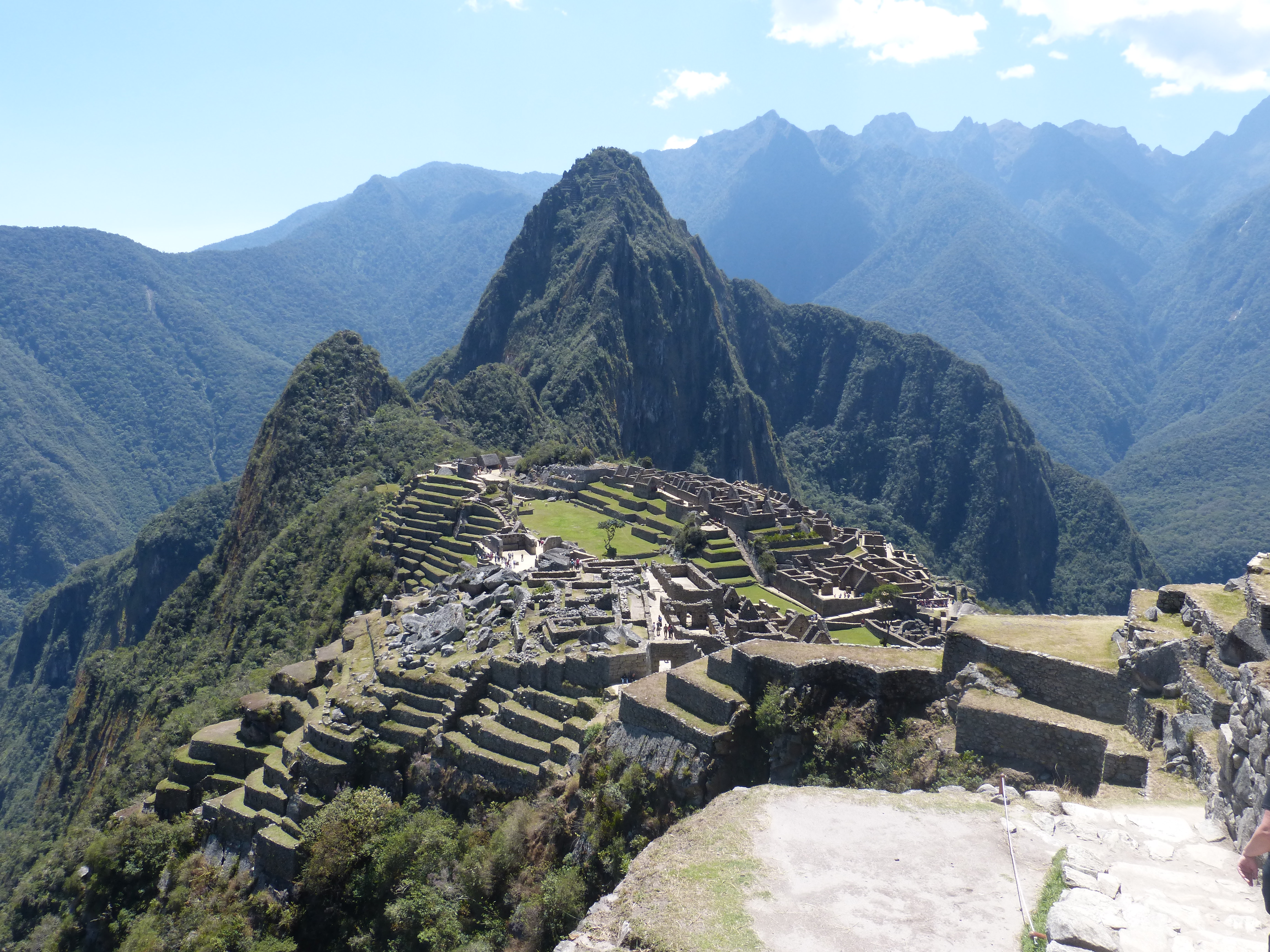A panoramic view of Machu Picchu terraces and stone buildings in the Andes.